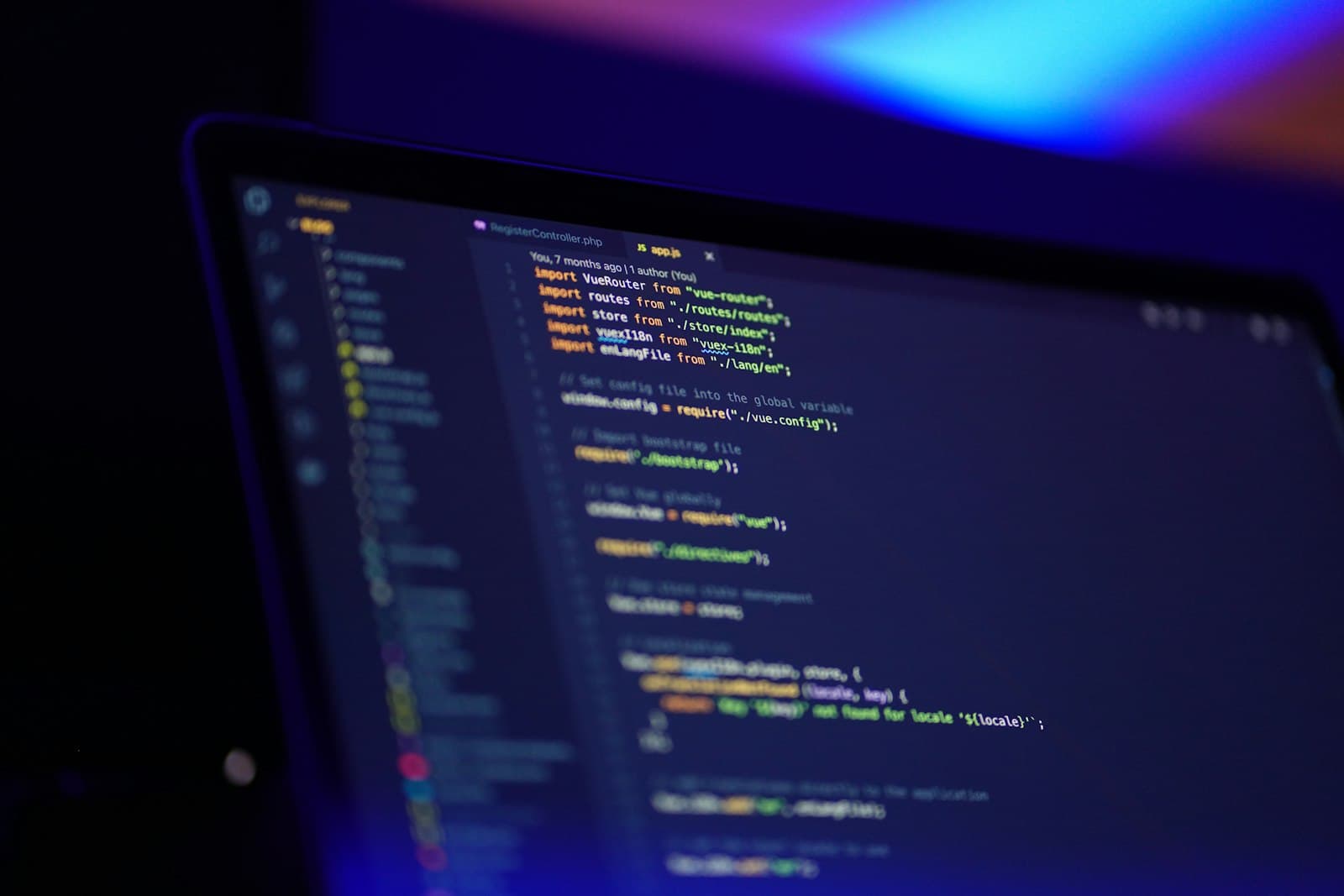 Vue.js source on a dark editor, color grading the screen blue and orange